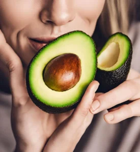 A lady smelling a well ripen avocado